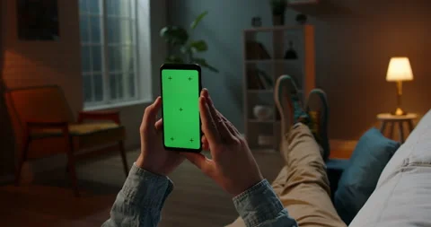 Close up shot of guy lying on couch at night, holding a smartphone with chroma Stock-Footage 133128067