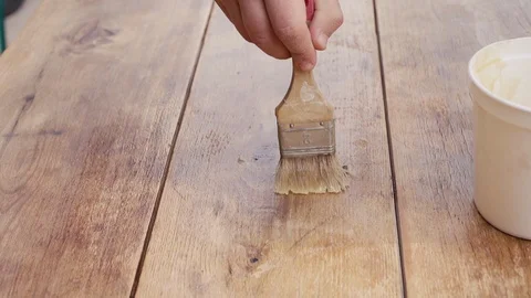 Close up shot of a guy taking care of wooden table Stock Footage 105690085