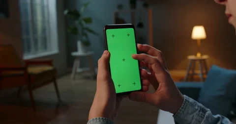 Close up shot of guy using his smart phone with mock up green screen at night Stock-Footage 136477905