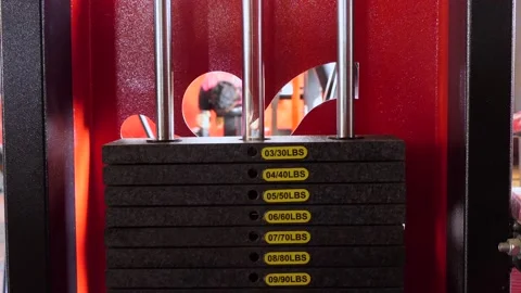 Close shot of gym exercise machine weight stack going up and down Stock Footage 147644654