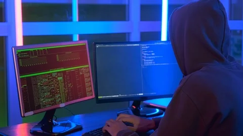 Close-up shot of of hacker dressed in a dark close working on computer Stock-Footage 124408123