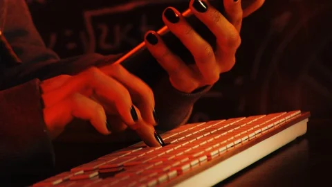 Close up shot of hacker hands with cellphone in hands Stock Footage 128748012