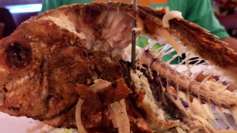 Close-up shot of a half eaten fried fish standing on top of a table Stock Footage 83098869