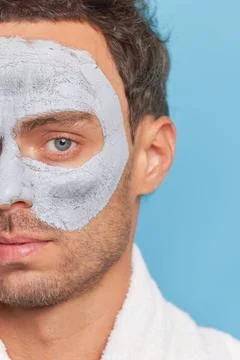 Close-up shot half face of handsome man with cosmetic clay mask on his face Stock Photos