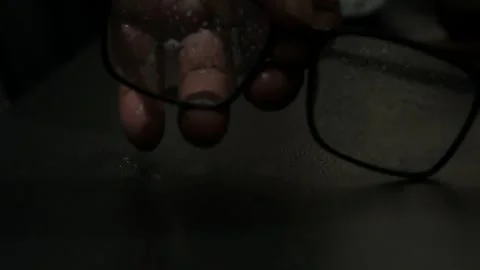 Close-Up Shot of Hand Cleaning Black-Framed Eyeglasses with Yellow Microfiber 스톡 동영상 345025133