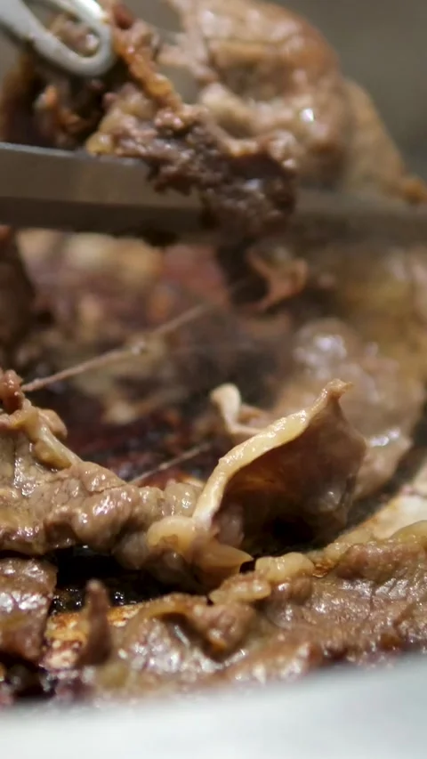 Close up shot of hand cooking Korean grilled pork belly meat and use scissors to Stock Footage 306932027