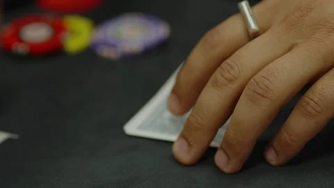 A close-up shot of a hand covering playing cards on table Stock Footage 336240360