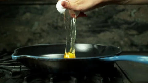 Close shot of hand cracking egg into pan Stock Footage 60113422