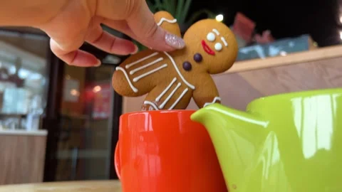 Close up shot of a hand dipping a biscuit into a cup of coffee Festive Christmas Stock Footage 260889299