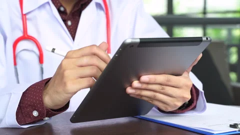 Close up shot hand of Doctors with stethoscope are using tablets to write tre Stock Footage 131929503