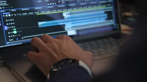 Close-up shot of a hand editing video on a laptop with professional software Stock Footage 318967752