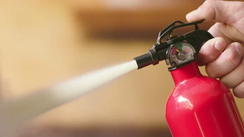 Close up shot of a hand grabbing a fire extinguisher and pulling the trigger. 스톡 동영상 151811752