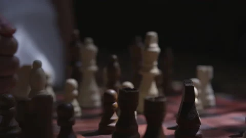 Close up shot of Hand Hitting Chess Game indoors in shadow room Stock Footage 208752299