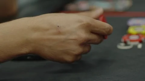 A close-up shot of a hand holding chips at poker table Stock Footage 336240370