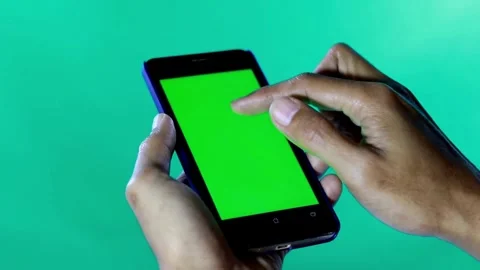 Close Up Shot of Hand of Man Holding his Smartphone with Green Screen click 스톡 동영상 336585711