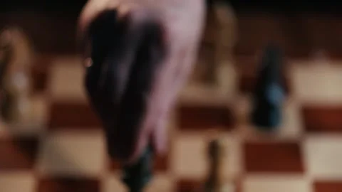 Close up shot hand of man moving queen chess on wooden chess board Stock Footage 131084789