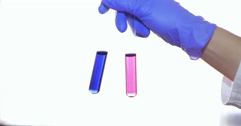 Close up shot of a hand mixing two test tubes with red and blue content Stock Footage 48979396