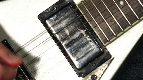 Close-up shot of a hand playing an electric guitar with the plettro, guitar pick Stock-Footage 72638964