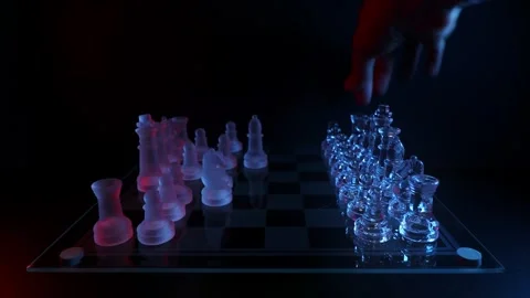 Close-up shot of a hand setting up transparent glass chess pieces on a chessboar Video stock 347189831