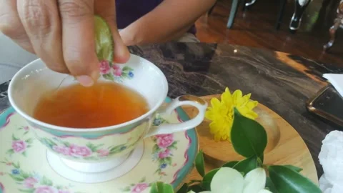 Close up shot of Hand squeezing a slice of lime. Hand Squeezing a Piece of Fresh Stock-Footage 336588823