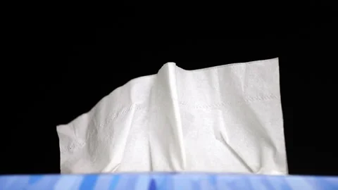 Close up shot of hand taking disposable paper tissues, box on black Stock Footage 142309674