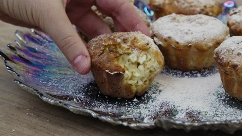 Close up shot of a hand taking a muffin and putting it bitten. Stock Footage 266427289