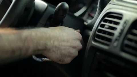 Close up shot of hand turning key inside car and starting engine Stock Footage 201240014