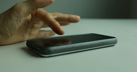Close up shot of hand using smartphone on table Stock Footage 112314427