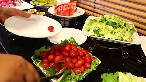A close up shot of a hand using tongs to pick up fresh red cherry tomatoes .. Stock-Footage 332771766