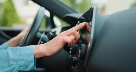 Close up shot hand of woman using touch screen in car setting up the navigation Stock Footage 249748120