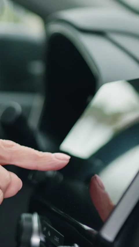 Close up shot hand of woman using touch screen in car setting up the navigation  Stock Footage 333916897
