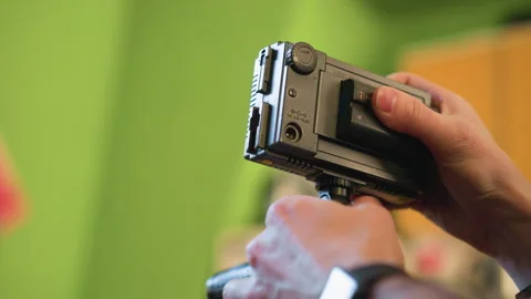 Close-up shot of hands adjusting camera gear, focusing on video camera setup Stock Footage 317547597