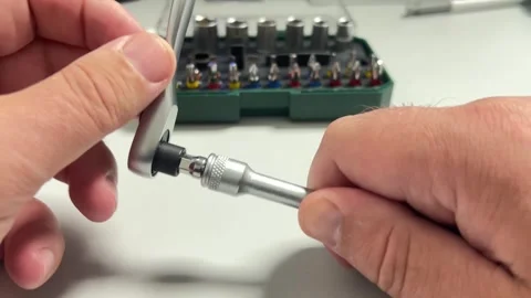 A close-up shot of hands assembling a ratcheting screwdriver or socket wren.. Stock Footage 323001269