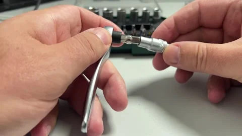 A close-up shot of hands assembling a screwdriver by inserting a magnetic s.. 스톡 동영상 323140849