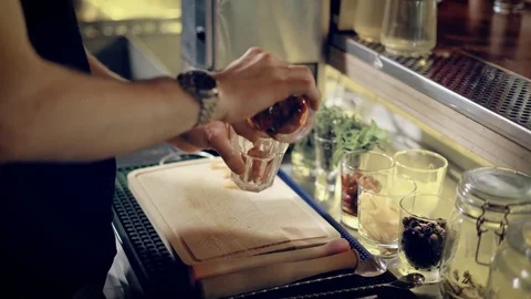 Close up shot of the hands of the bartender, who mixes the ingredients for the Video stock 78000744