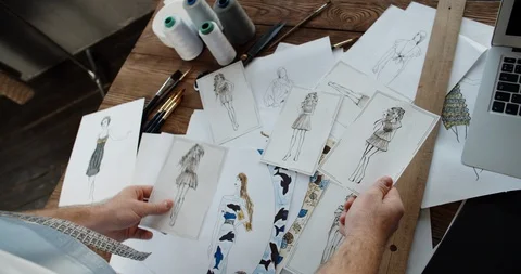 Close-up shot of hands of a clothes designer touching different beutiful Stock-Footage 124617909