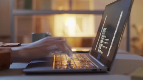 Close-up shot of hands of Computer programmer making a new program Using Video stock 334586052