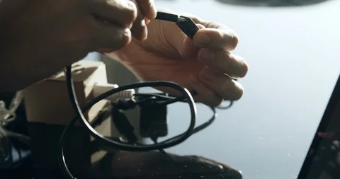 Close up shot of hands connecting USB peripheral cords and adaptors Stock Footage 104071440