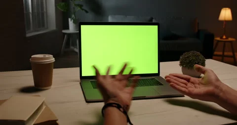 Close up shot of hands of distance workerhaving an online video conference at Видео 132068653