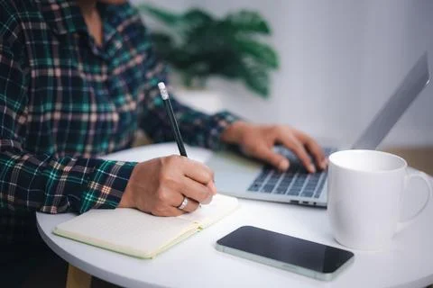 Close up shot hands of freelancer use laptop working on desk of her this is.. Stock Photos