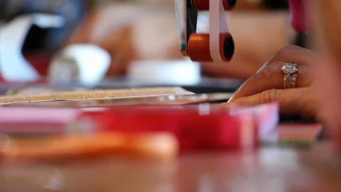 A close shot of hands gluing on paper on scrapbook Stock Footage 115213232
