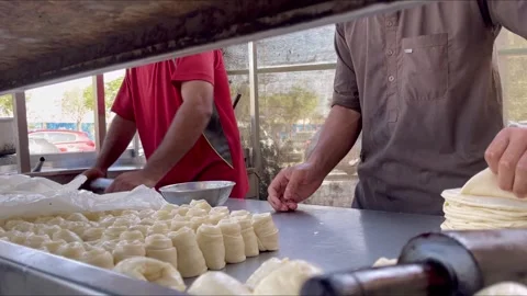 Close up shot of hands of local cooks making laccha paratha in an outdoor 스톡 동영상 244310072