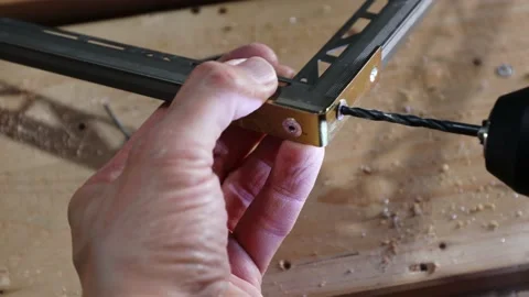 Close up shot on hands of man removing rivets from aluminium profiles. Stock Footage 140724533