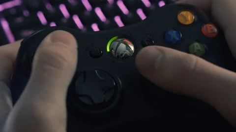 Close shot of the hands of a mand using an xbox controller while gaming. Stock Footage 128346951