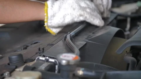 Close up shot hands of the mechanic checking a front car engine Stock Footage 344915195