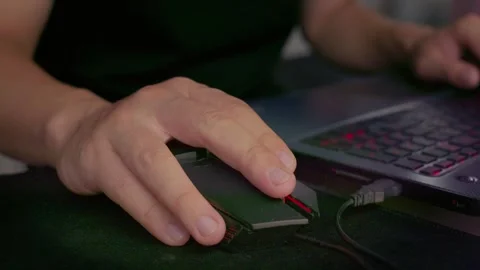 Close-up shot of hands operating a computer mouse while sitting at desk Stock Footage 337450998
