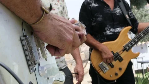 Close up shot of hands playing an electric guitar and bass. Stock Footage 197295389