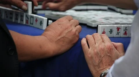 Close up shot of hands playing mah jong at People's square park in Shanghai Stock Footage 56801896