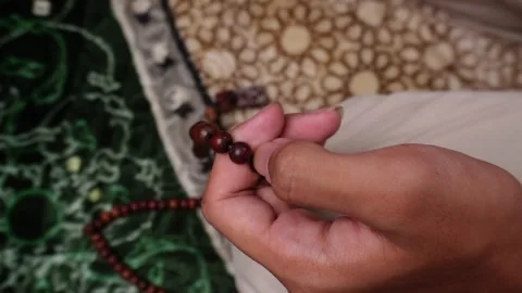 Close up shot of hands in prayer on rug or mat Stock Footage 268377922
