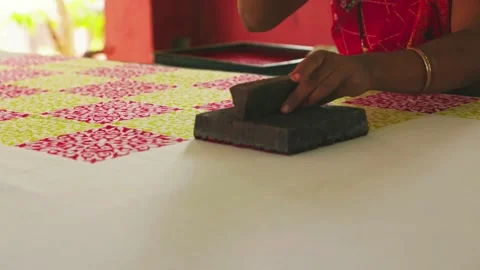 Close Shot of Hands Printing on Linen with Wooden Block in Workshop Stock Footage 320930432